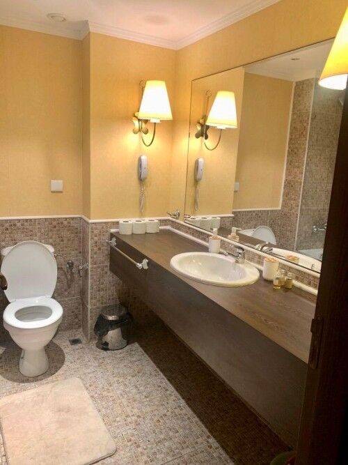 Bright bathroom with modern fixtures and mirror.