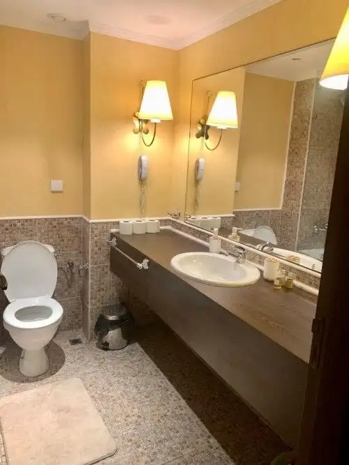 Bright bathroom with modern fixtures and mirror.