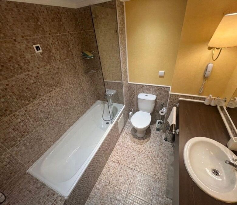 Comfortable bathroom with bathtub and modern fixtures.