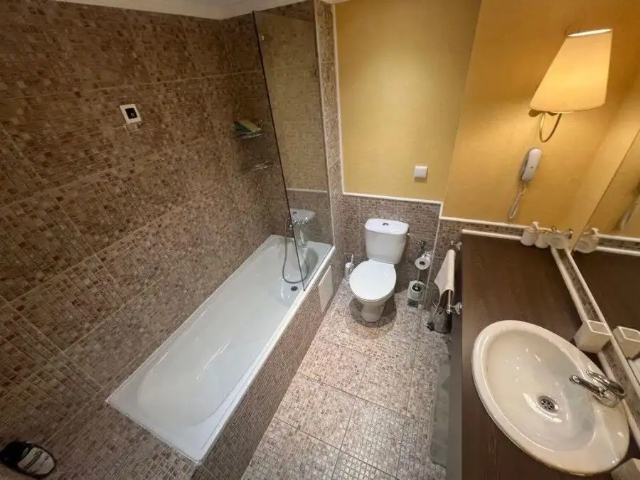 Comfortable bathroom with bathtub and modern fixtures.