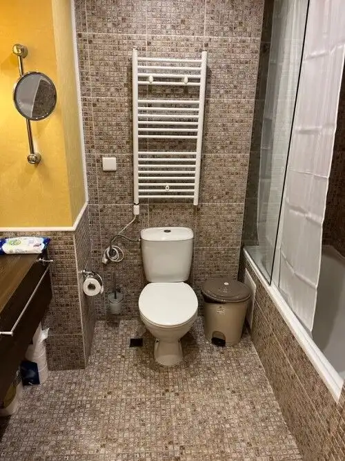 Small bathroom with toilet, towel radiator, and shower in Barcelo Royal Beach, Sunny Beach.