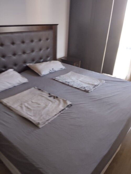 Comfortable bedroom with neatly made bed and soft pillows in a stylish apartment.