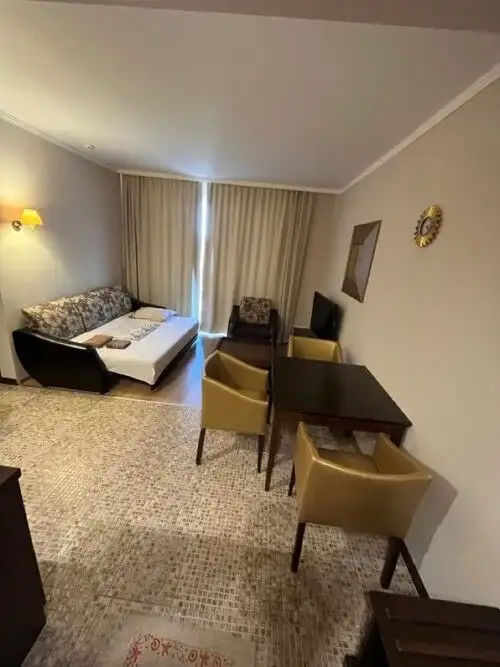 Bright living room with sofa and dining area in Barcelo Royal Beach.