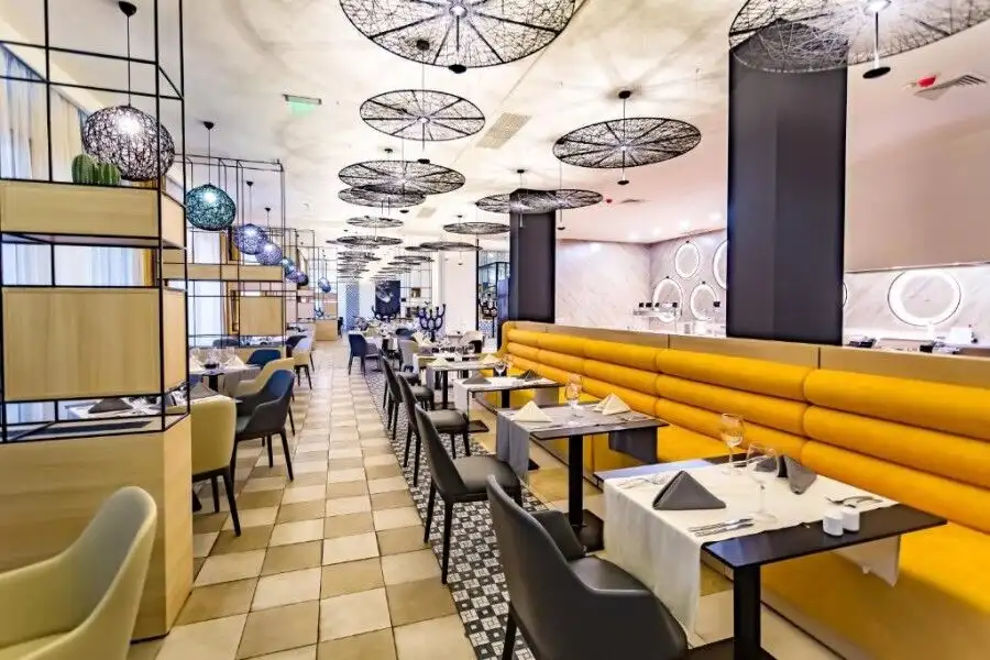 Spacious restaurant with contemporary design, elegant lighting, and comfortable seating arrangements.