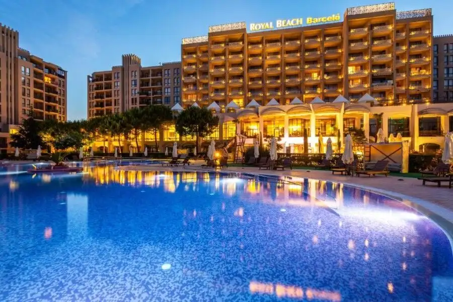 Pool view of Barcelo Royal Beach hotel in Sunny Beach with illuminated swimming pool and hotel facad.