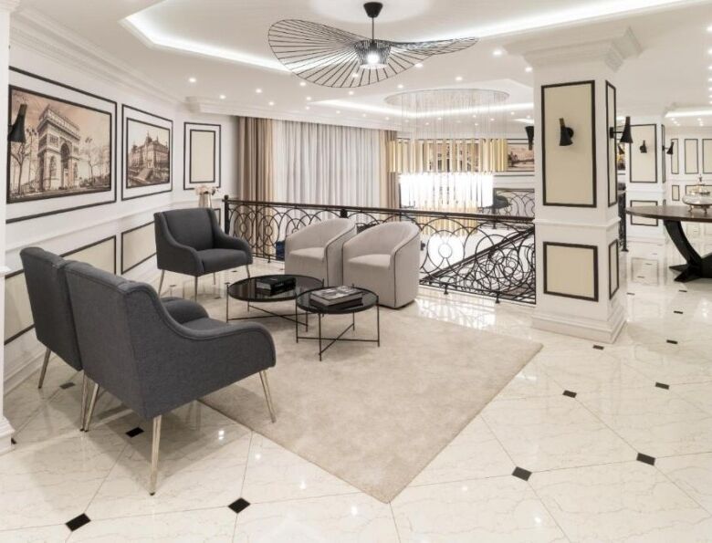 Luxurious living room with contemporary furniture, artwork, and bright lighting in a high-end apartm.