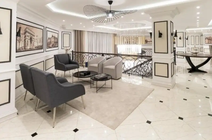 Luxurious living room with contemporary furniture, artwork, and bright lighting in a high-end apartm.