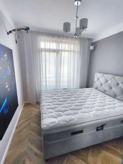 Bright bedroom with a comfortable bed and scenic sea view in Sveti Vlas.