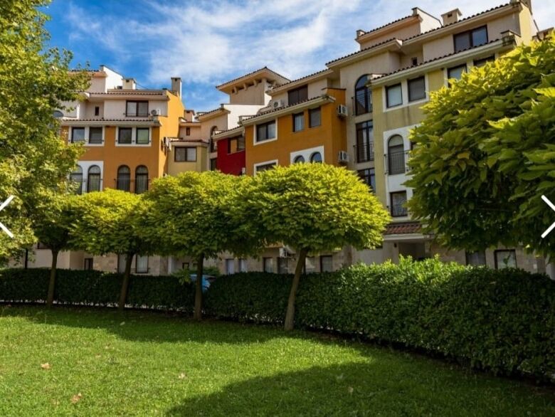 Colorful apartment complex with lush green landscaping at Marina Cape, Aheloy.