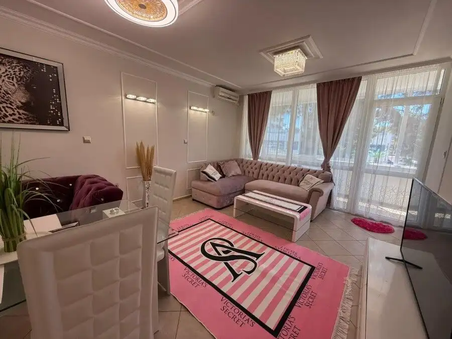 Bright and spacious living room with stylish furnishings and large windows.