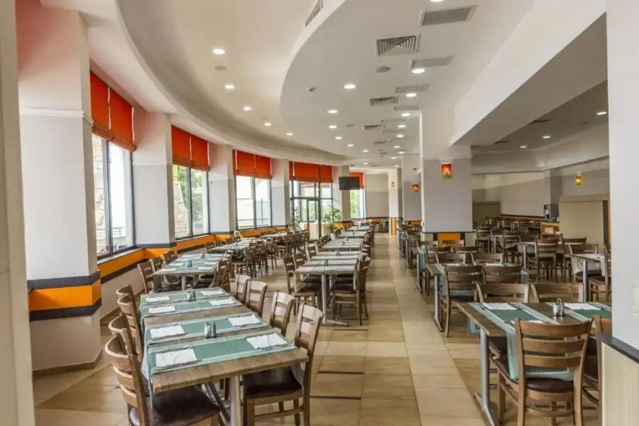 Spacious dining area in a contemporary restaurant with ample seating and natural light.