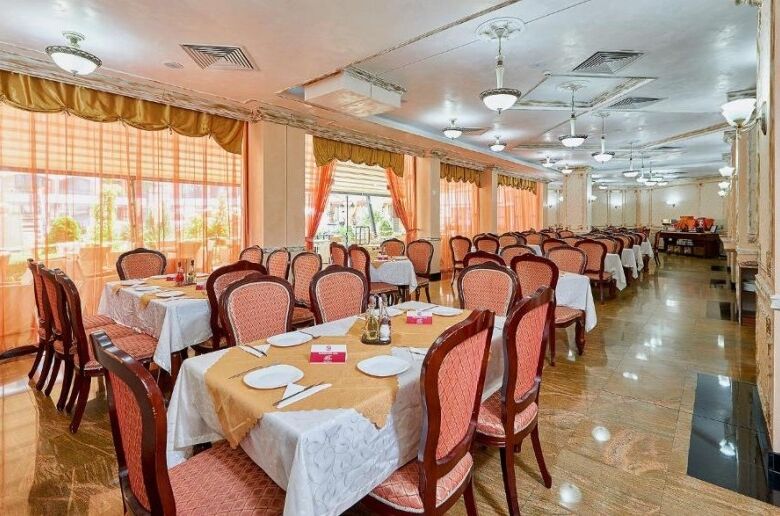 Bright dining area with elegant tables and chairs in a spa resort setting.