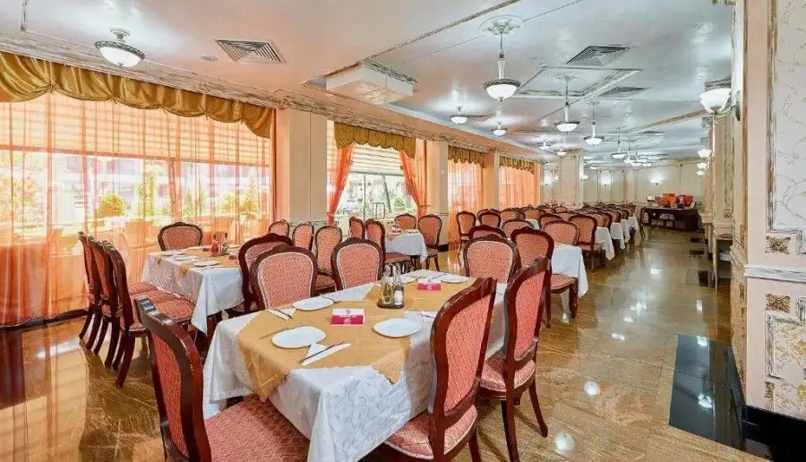 Bright dining area with elegant tables and chairs in a spa resort setting.