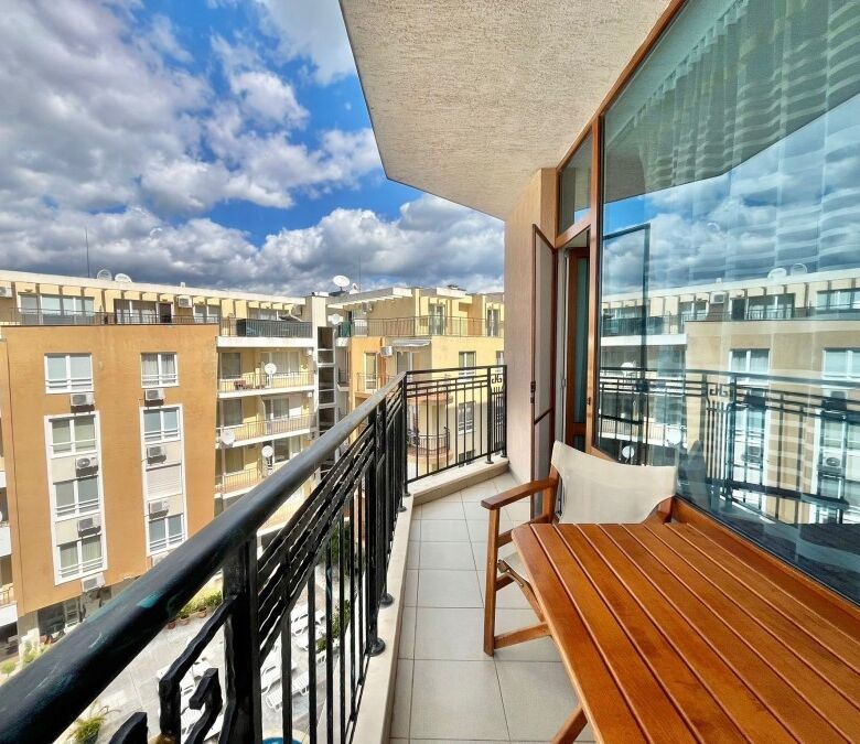 Bright balcony view of Sunny Beach with cityscape and blue sky.