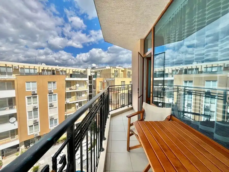 Bright balcony view of Sunny Beach with cityscape and blue sky.