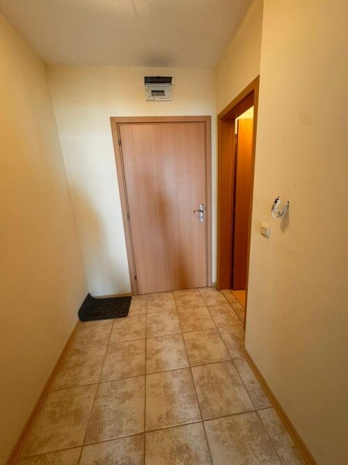 Interior view of a small hallway leading to a 1-bedroom apartment with sea views.