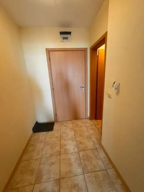 Interior view of a small hallway leading to a 1-bedroom apartment with sea views.