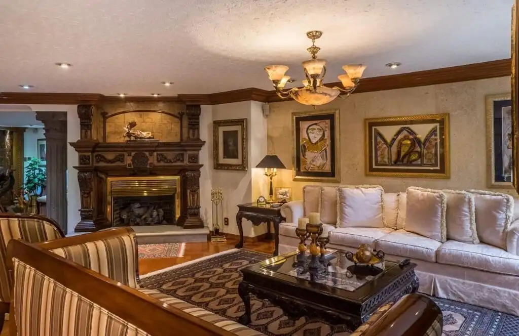 Elegant living room in a luxury Mexico City apartment with classic decor and cozy fireplace.