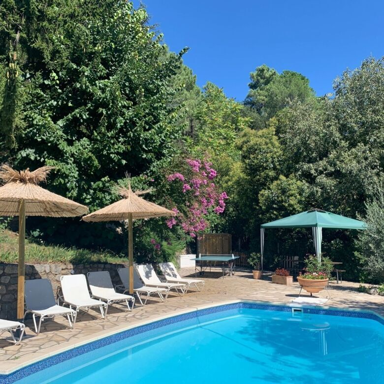 Luxurious 5-bedroom villa with private pool in Arles-sur-Tech, surrounded by lush greenery and outdo.