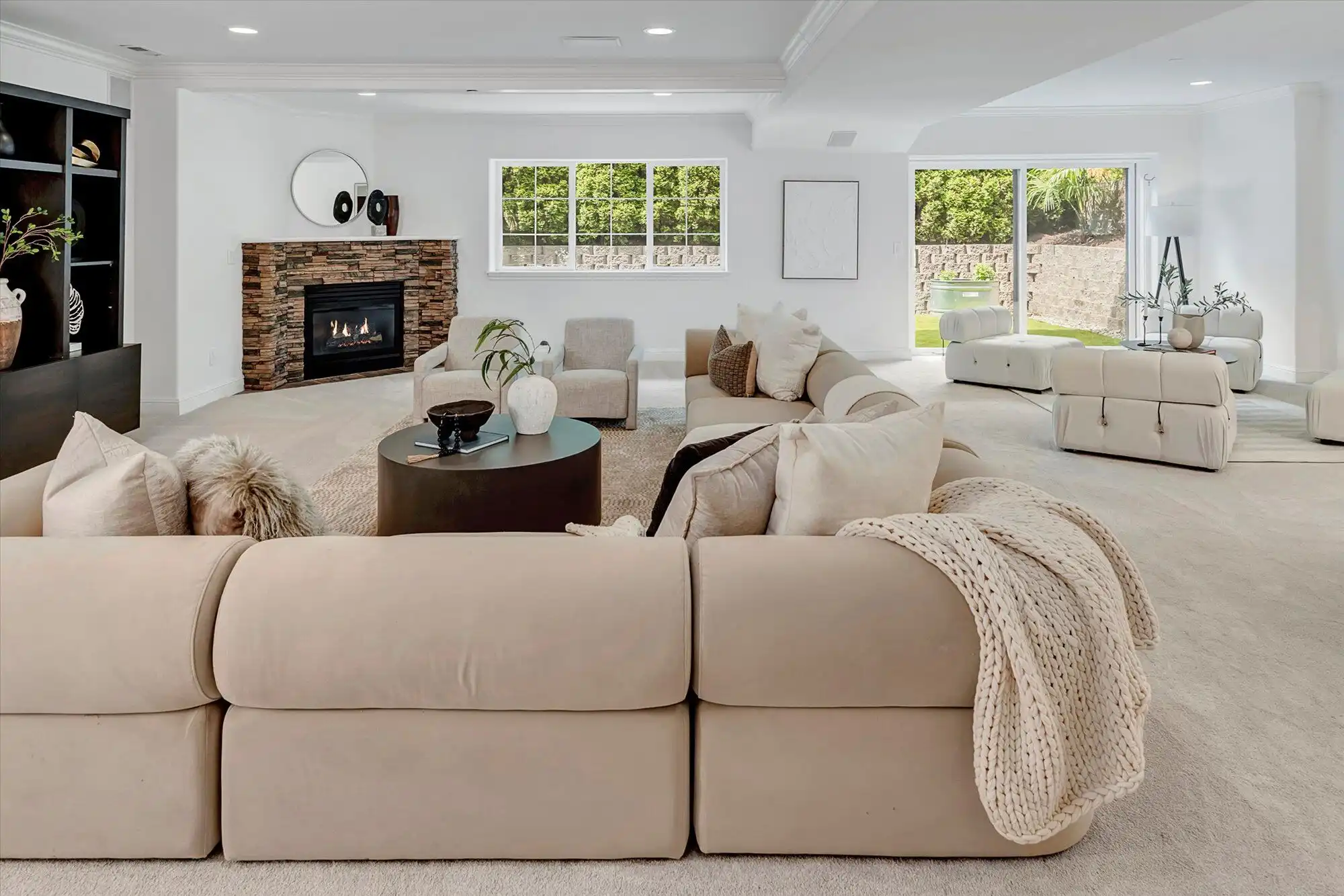 Luxury lakefront home with spacious, modern living room and large windows overlooking the water.