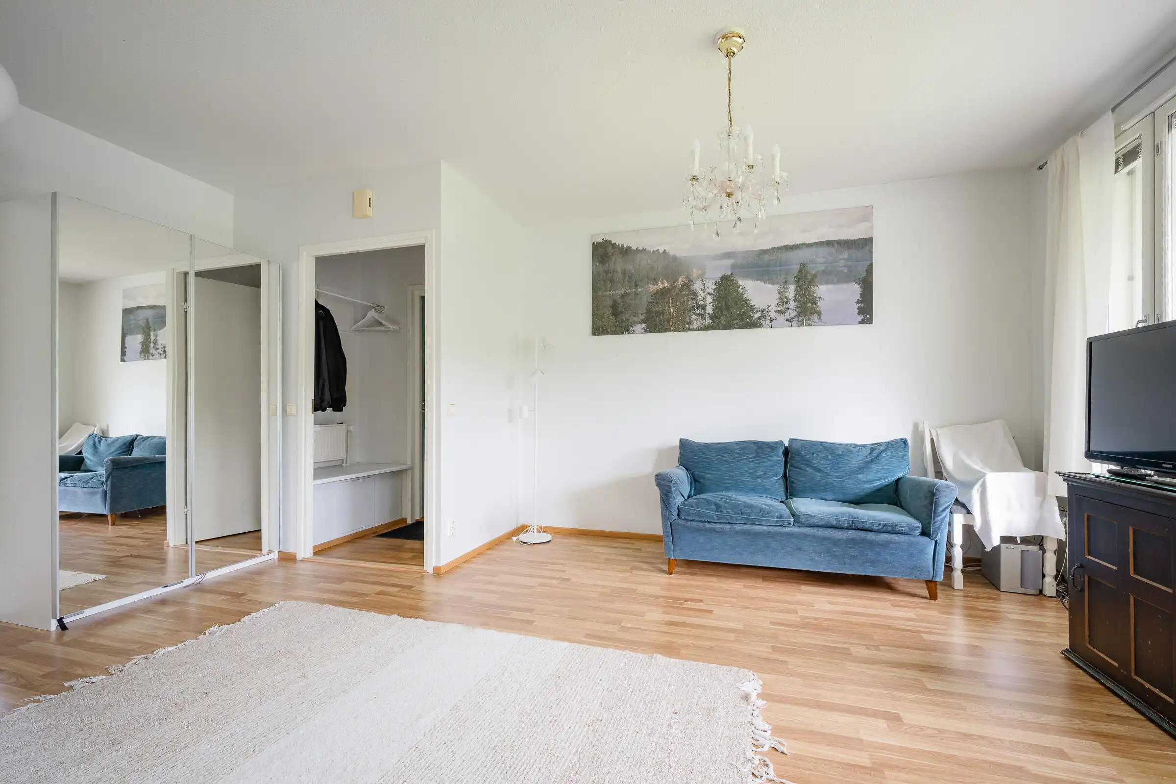 Bright living room with large windows and modern decor in Hirvensalo, Turku. Perfect for relaxing in.