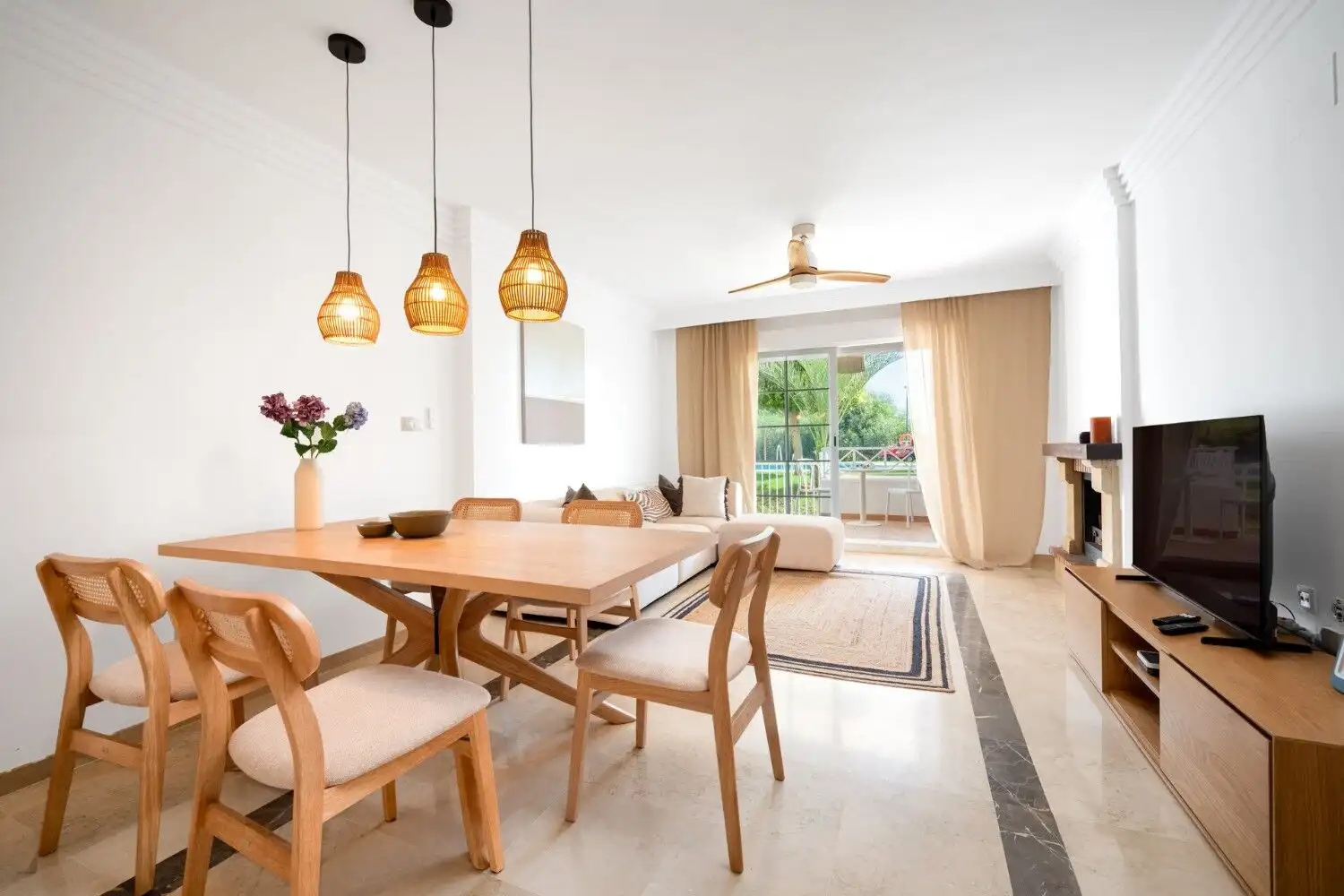 Renovated Marbella East apartment featuring a bright living and dining space with balcony access and.