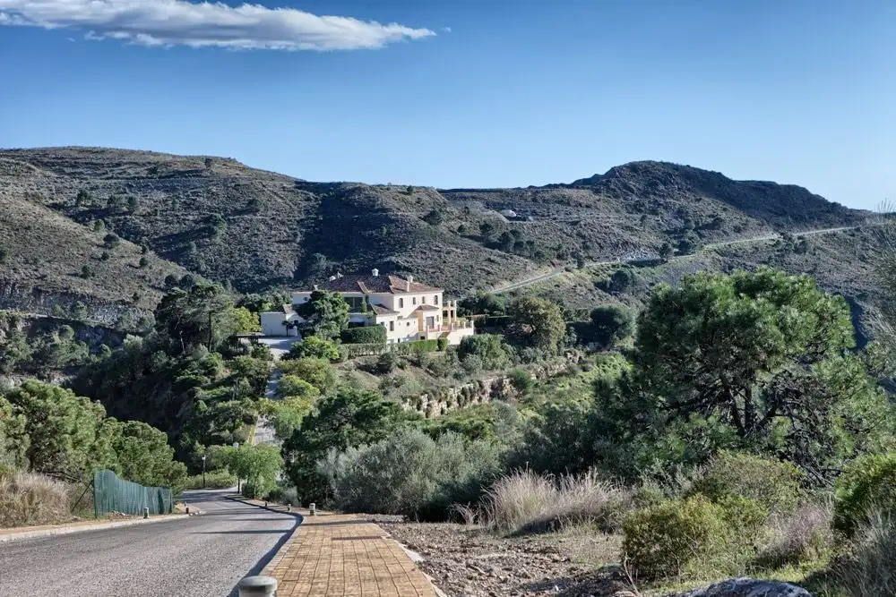 Luxury estate overlooking Marbella Golf Resort with scenic mountain views.