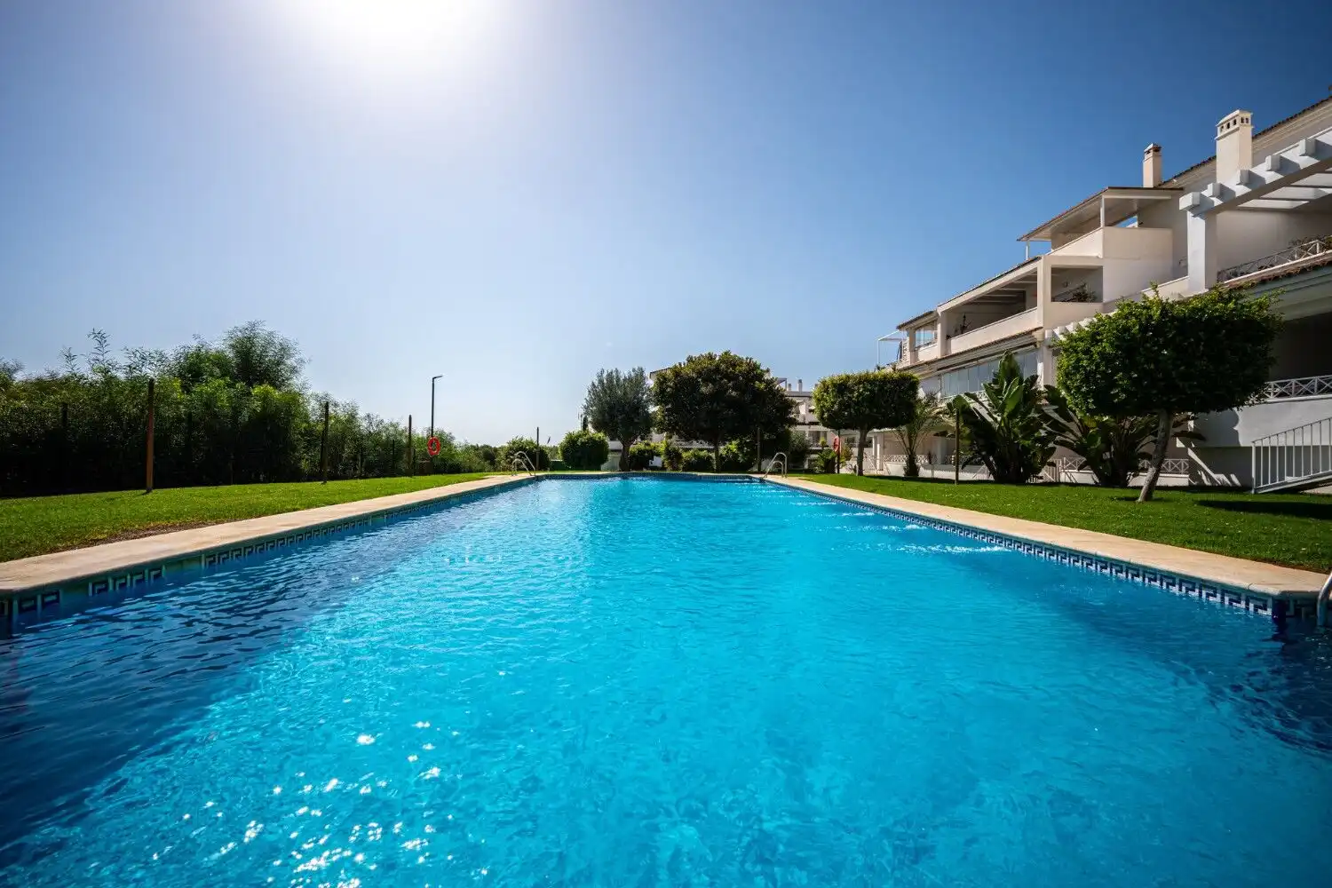 Pool view of a beautifully renovated apartment in Marbella East. Modern amenities and scenic surroun.