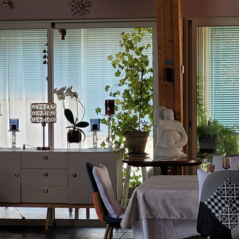 Spacious living room with large windows and elegant decor in Aumagne. Bright, airy interior perfect.