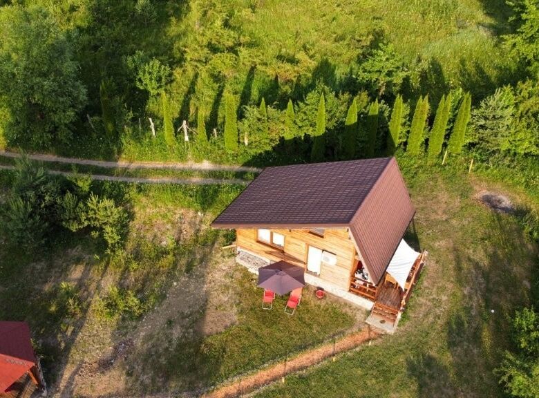 Cozy 1-bedroom log cabin for sale in Grozăvești surrounded by lush greenery and nature. Perfect for.