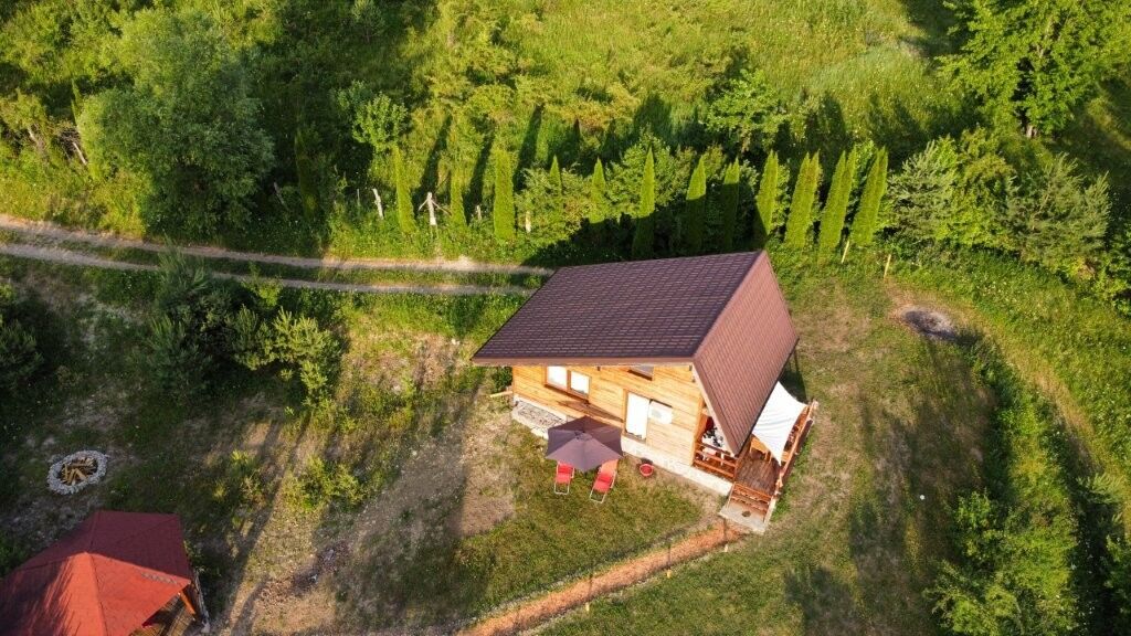 Cozy 1-bedroom log cabin for sale in Grozăvești surrounded by lush greenery and nature. Perfect for.
