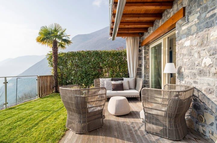 Elegant outdoor terrace with mountain views and modern furniture in Spiglia.