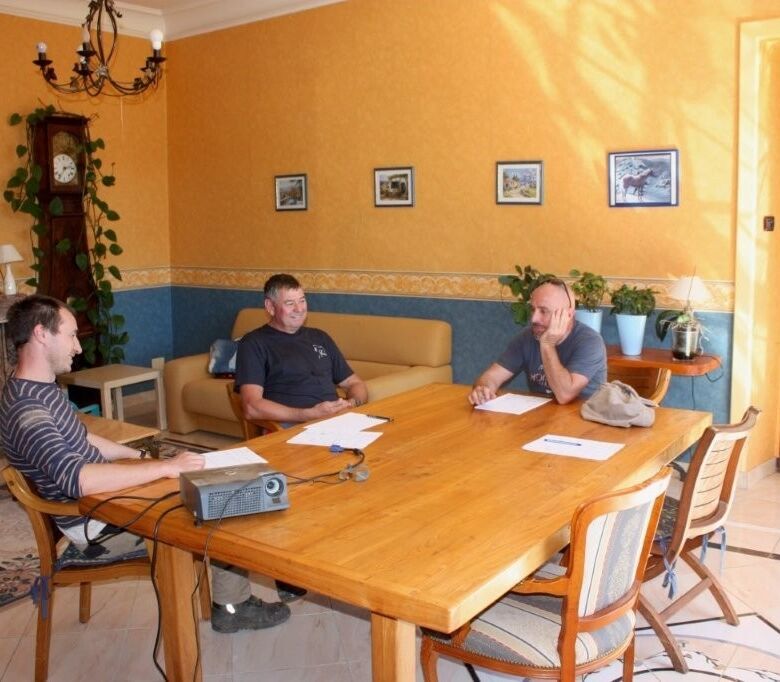 Business meeting in a cozy, well-lit room at Chateau de Montcru, Allières Ariège.