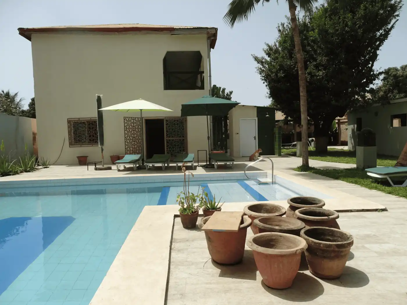 Beautiful outdoor pool area at a boutique B&B in The Gambia. Perfect for relaxing and enjoying tropi.