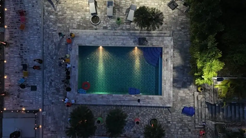 Aerial view of a luxurious resort-style villa with a pool in La Trinidad, surrounded by lush greener.