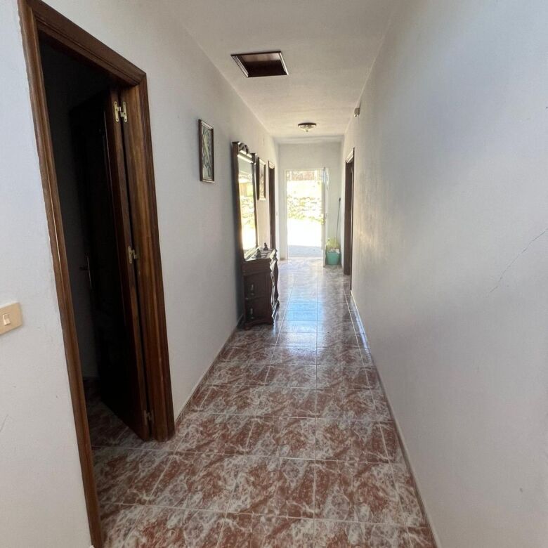 Spacious hallway inside a beautiful 6-bedroom house in Taboada, Galicia. Bright, airy corridor with.