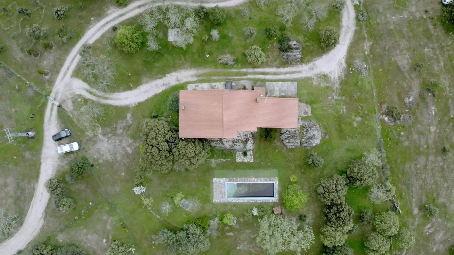 Aerial view of a rustic stone house with private woodland and a swimming pool in Salamanca. Perfect.
