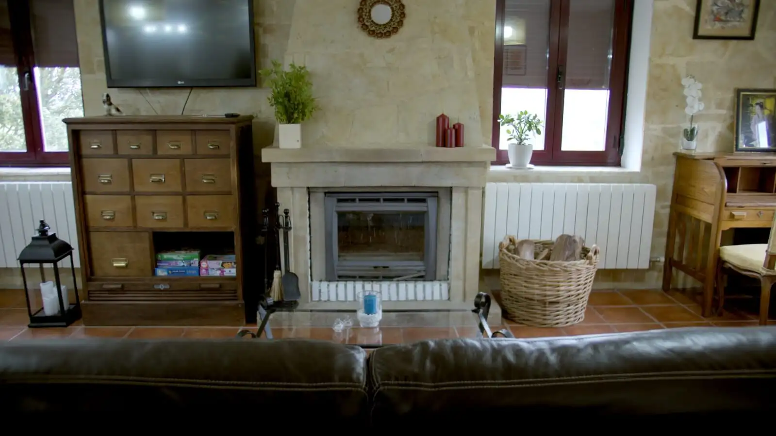 Cozy living room with stone fireplace and wooden furniture in Salamanca estate.