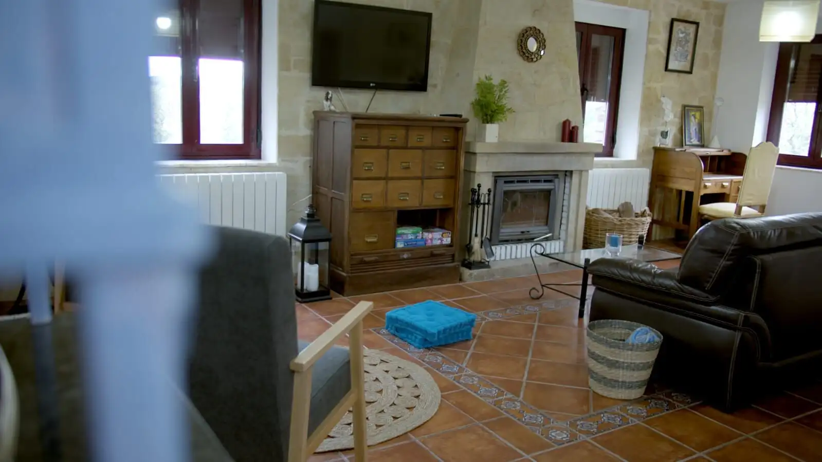 Interior view of a rustic living room with fireplace and wooden furniture in Salamanca estate.