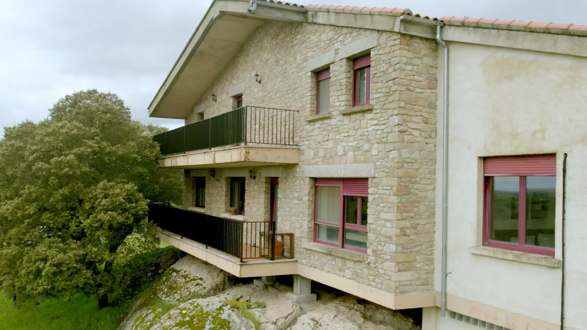 Charming stone house with balconies and surrounding woodland in Salamanca for sale.