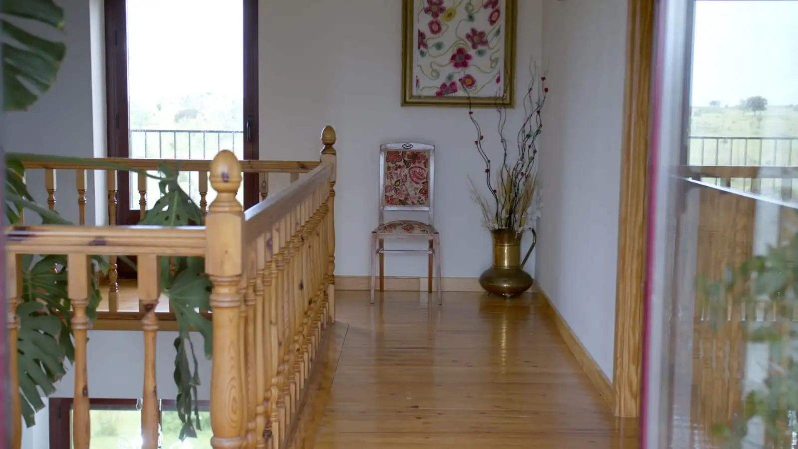 Interior view of a rustic stone house with wooden floors and large windows in Salamanca.