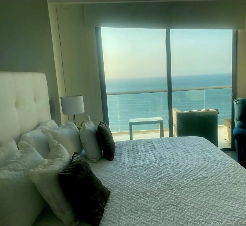 Modern bedroom with ocean view in Gaira Playa Salguero penthouse.