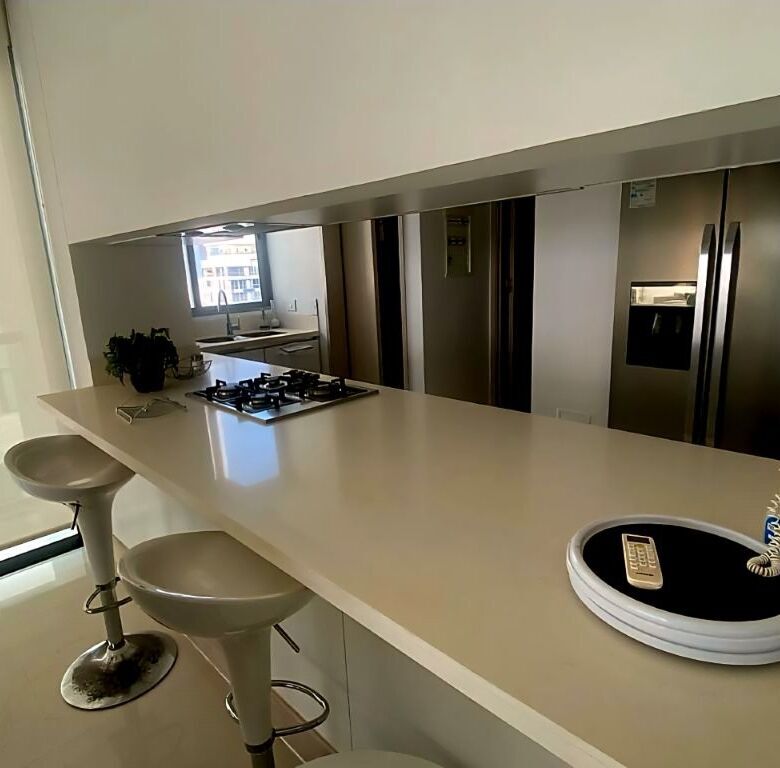 Spacious kitchen area with seating and high-end appliances in a Gaira Playa Salguero property.