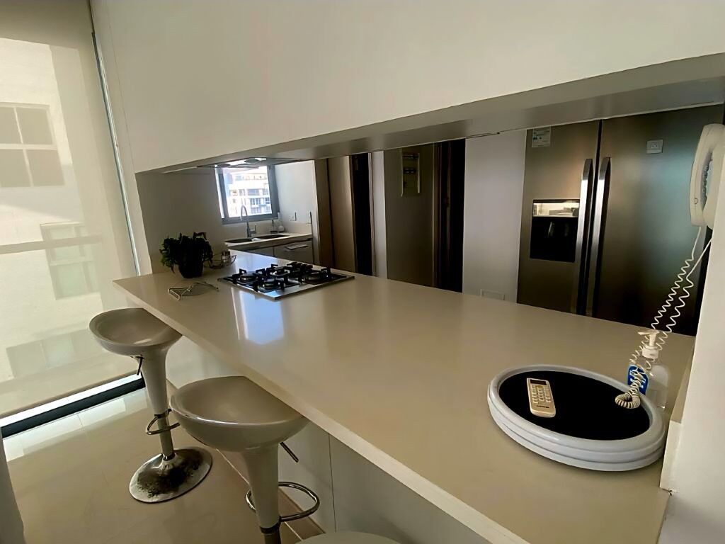 Spacious kitchen area with seating and high-end appliances in a Gaira Playa Salguero property.