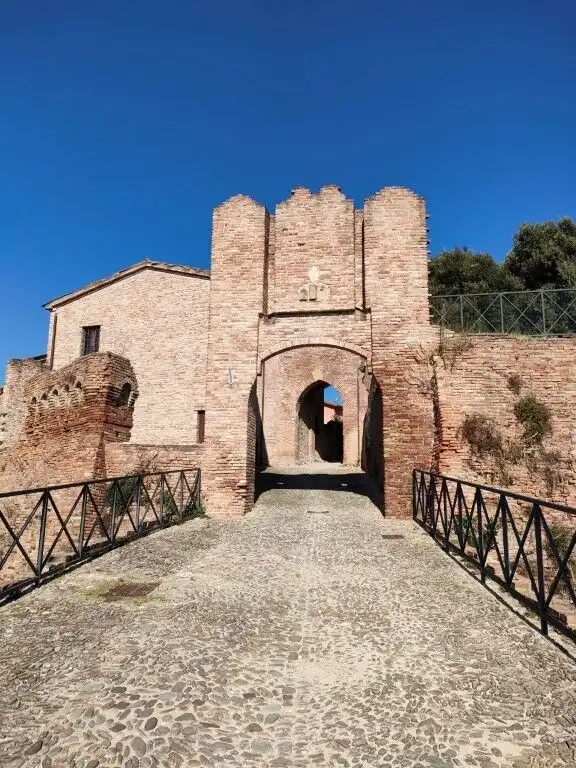 Historic castle gate in Coriano Rimini, Italy, showcasing medieval architecture and stone constructi.
