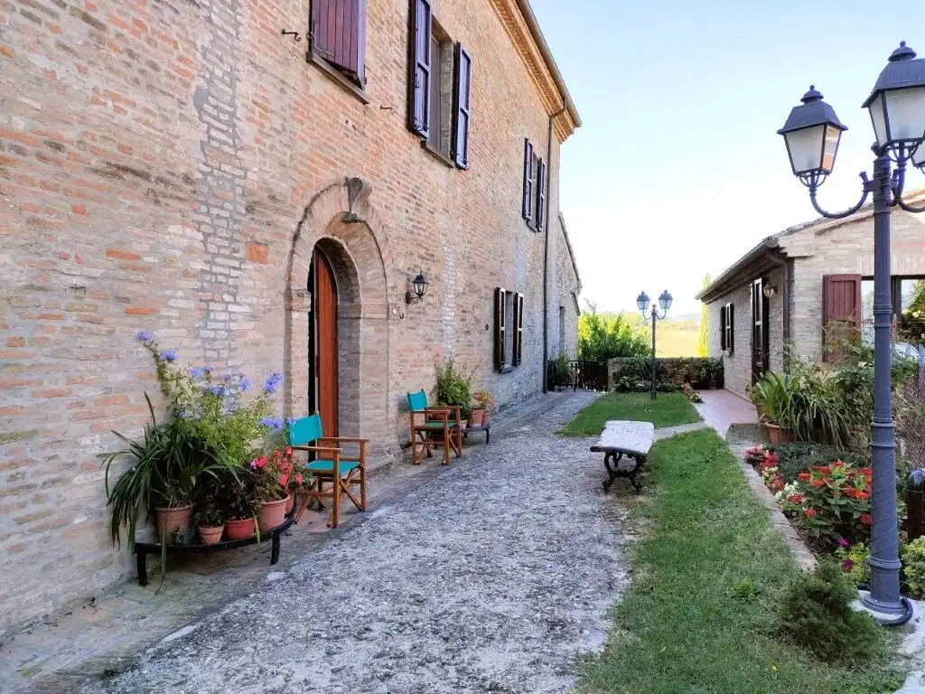 Style 3-bed house for sale in Coriano Rimini, featuring historic architecture and scenic outdoor spa.