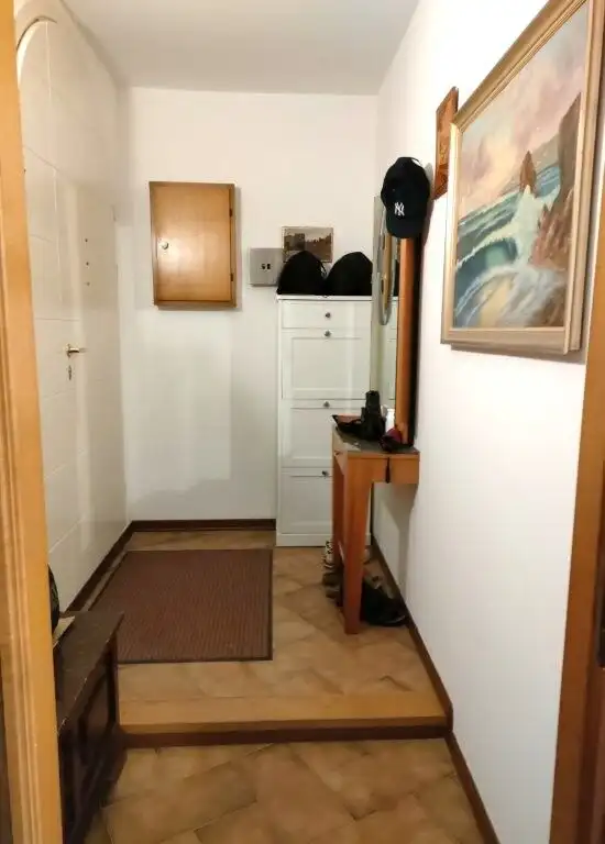 Bright entrance hall with wooden accents and artwork in Coriano Rimini.