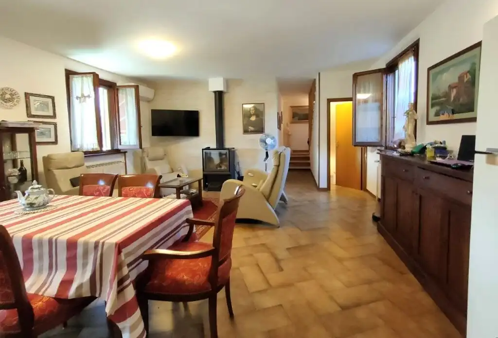 Interior view of a charming castle-style house with a warm living room and dining area.