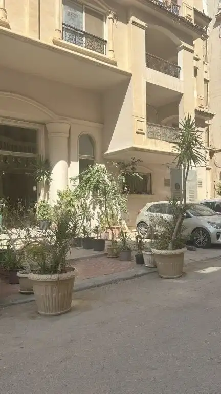 Modern luxury 3-bedroom apartment in Cairo with elegant exterior and balcony views.