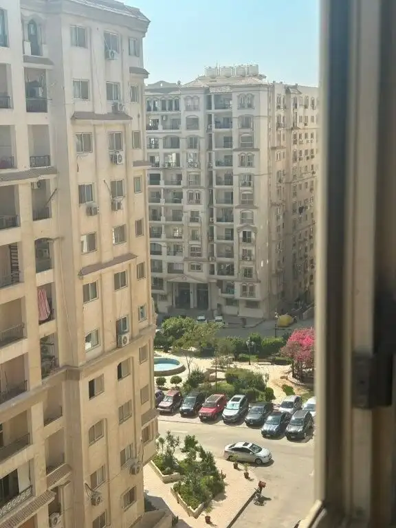 View of Cairo apartment buildings from window, showcasing urban residential area.